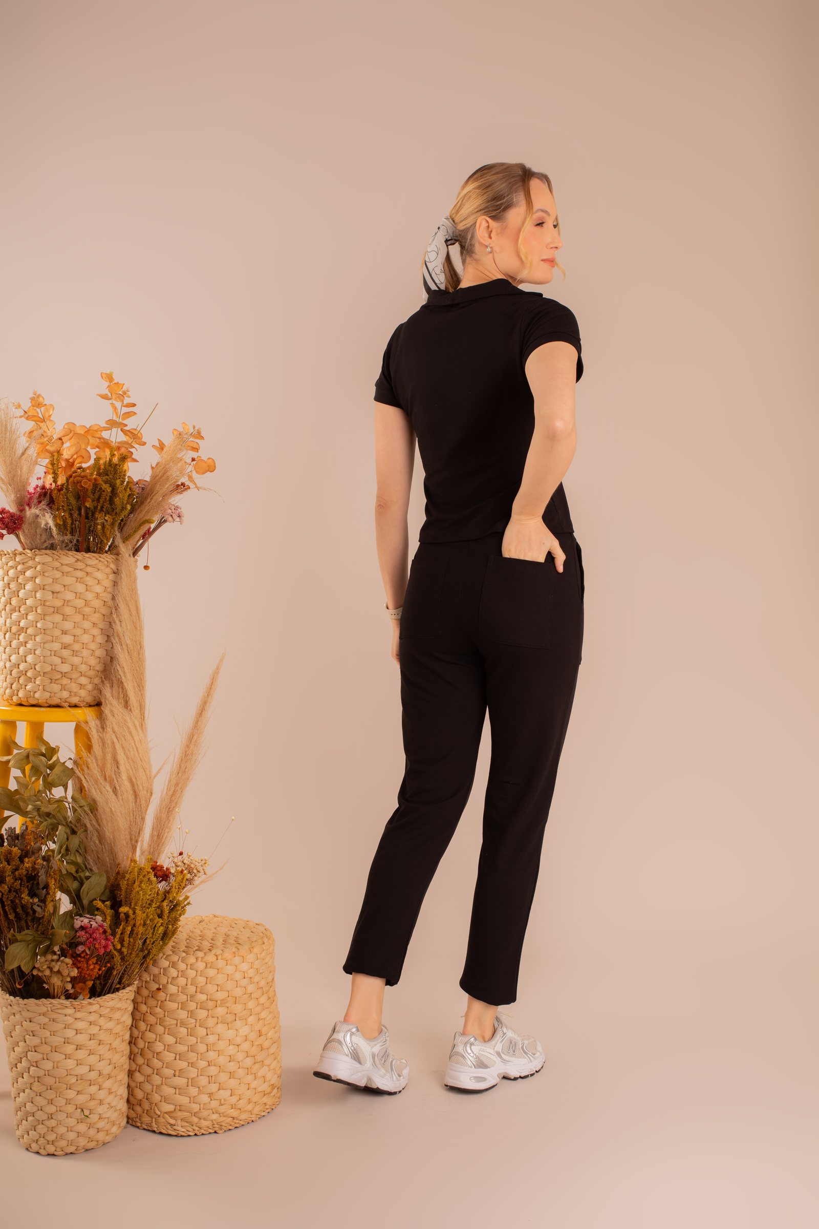 Camiseta polo preta e calça preta, costas